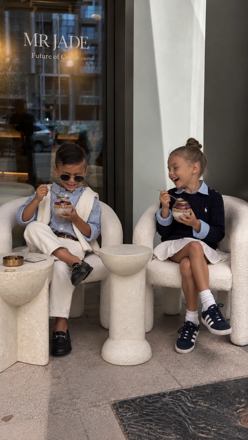Two young guests enjoying granola cups outside MRJADE Coffee