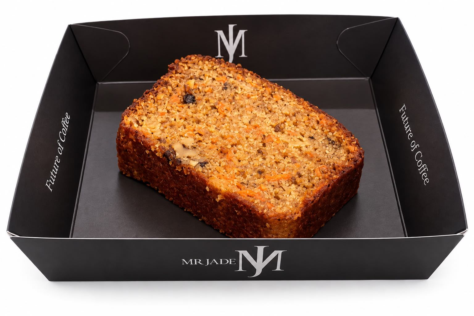 Loaf-style carrot cake slice in a black MR JADE Future of Coffee box