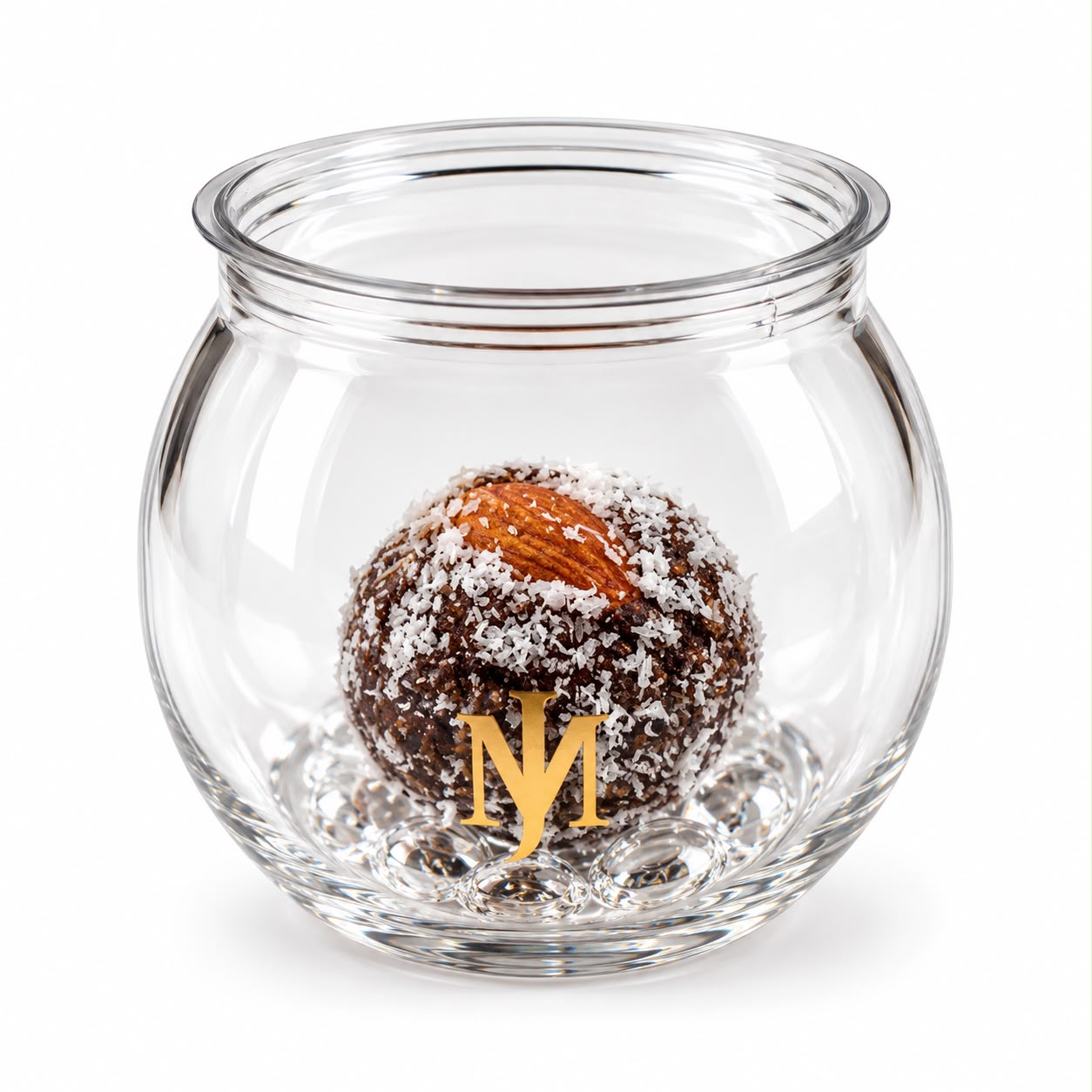 Date energy bite rolled in coconut and topped with an almond, in a gold-lid MRJADE glass jar