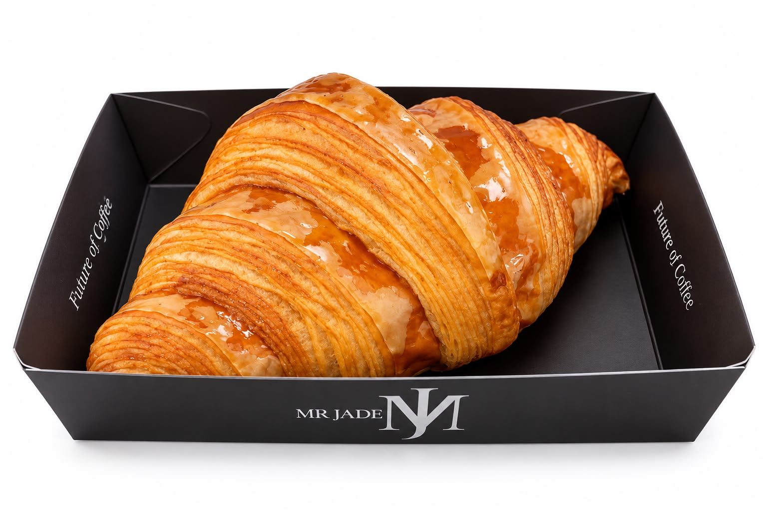 Golden butter croissant in a black MR JADE Future of Coffee box